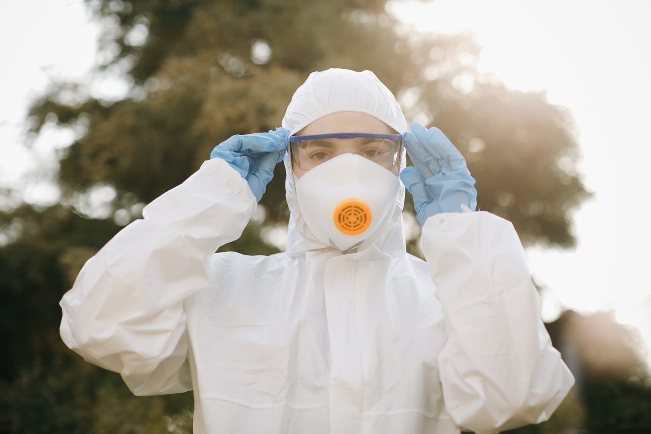 An employee wearing a full protective suit at work