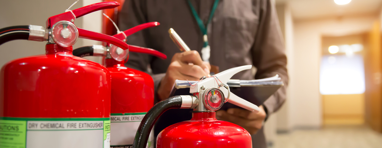 An employee checking fire extinguishers