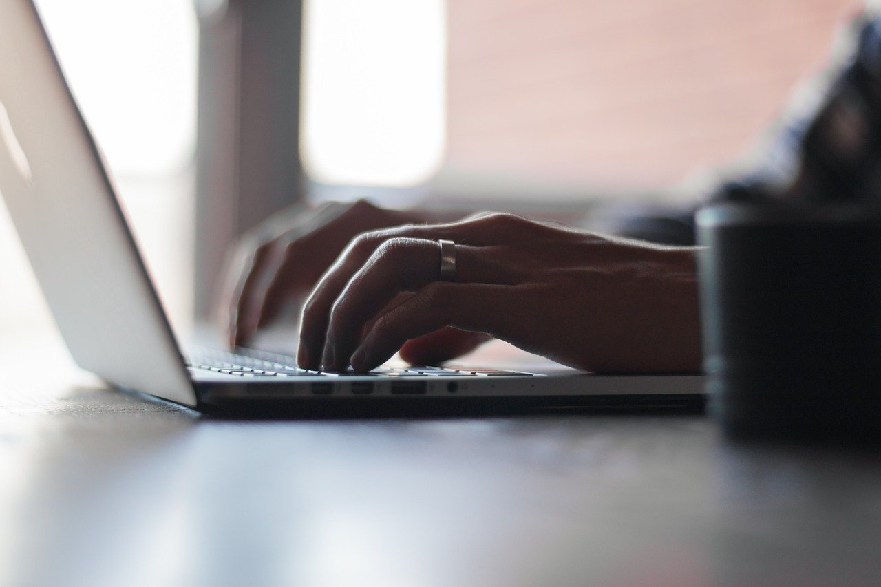 A man typing on a laptop