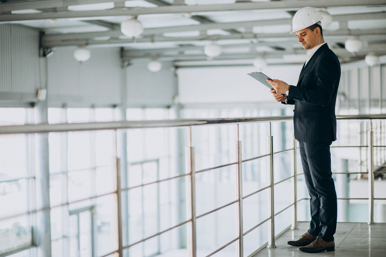 A businessman overlooking his industrial investment