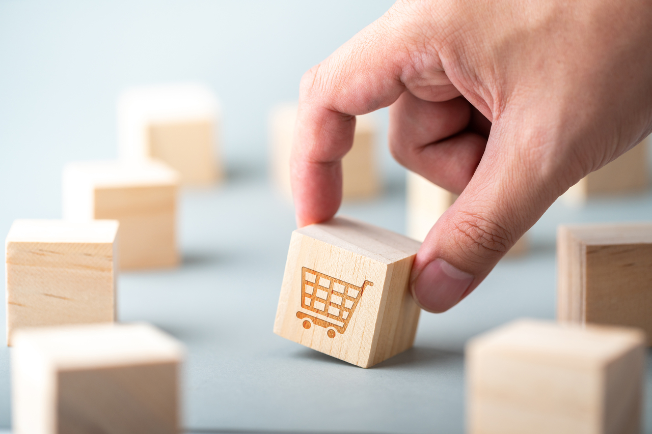 A man holding a block with a symbol of e-commerce